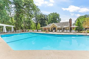 A large swimming pool in front of a house. at Southpark Commons Apartment Homes, Charlotte, NC, 28210